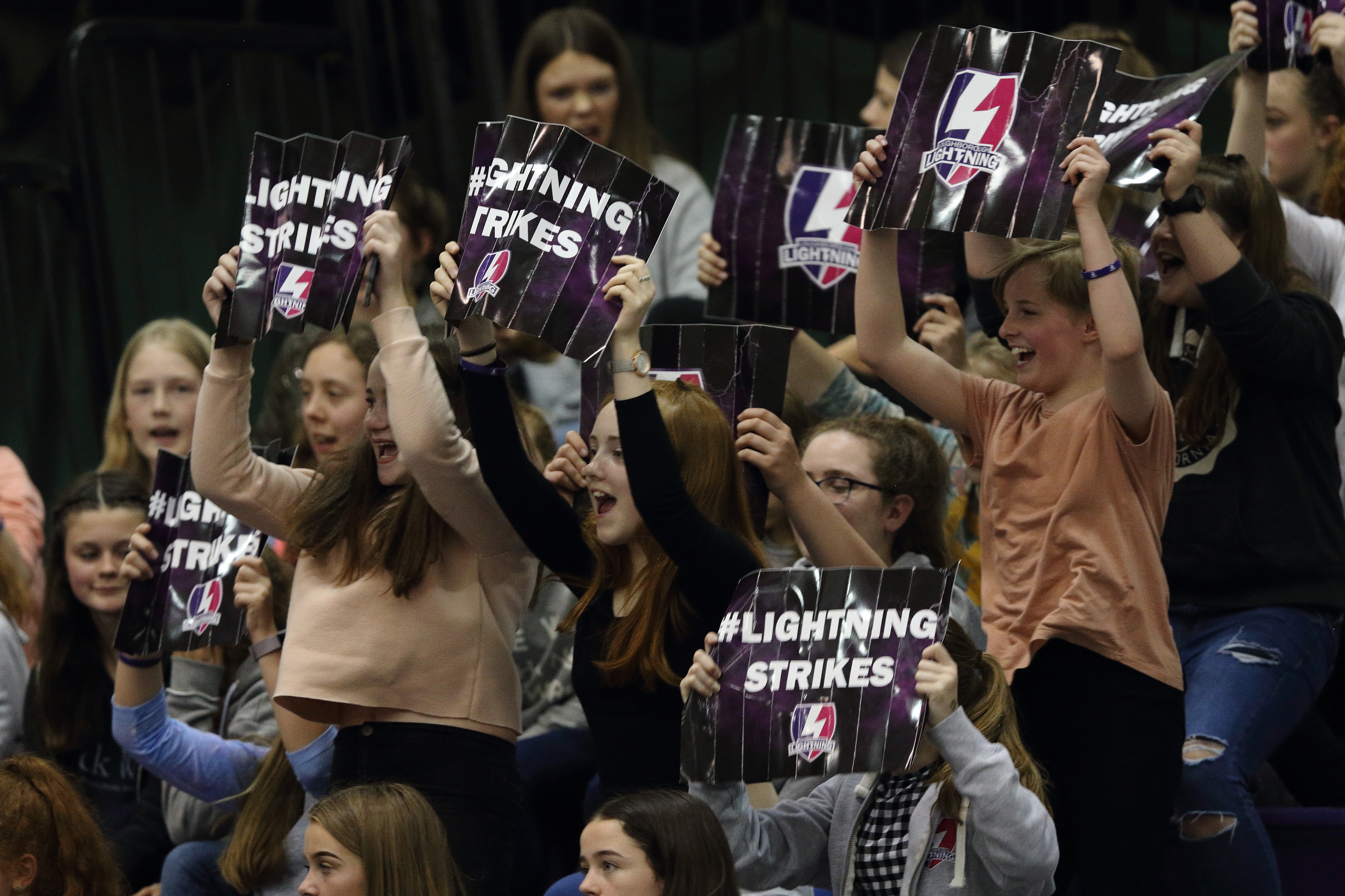 fans holding up signs with text 'Lightning strikes'